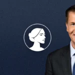 A man in a dark suit and blue tie smiles in front of a dark blue background featuring a white icon of a woman's profile in a circle, supporting Jefferson Shreve's Pro-Life stance.