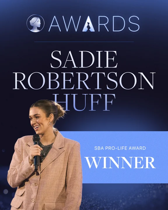 Sadie Robertson Huff smiles and holds a microphone on stage. Text reads: SBA Life Awards, Sadie Robertson Huff, Pro-Life Award Winner with a silhouette award logo at the top.