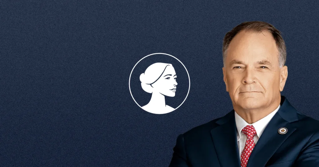 A man in a dark suit and red tie stands in front of a blue background with a white logo featuring a woman's profile, representing TX-02 candidate Steve Toth's pro-life values.