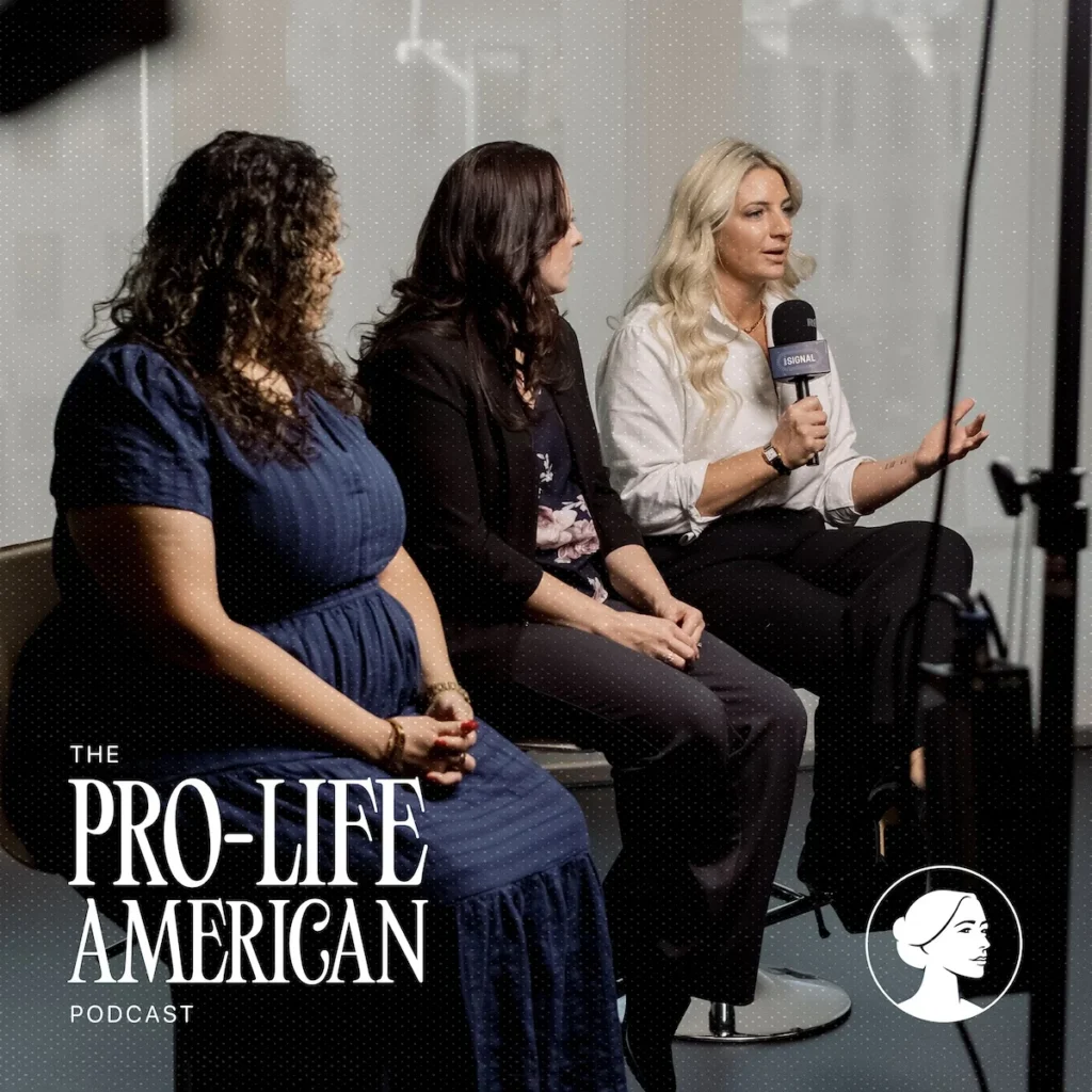 Three women sit in chairs during a Pro-Life American podcast recording, with one woman speaking into a microphone. Text in the bottom corner reads The Pro-Life American Podcast.